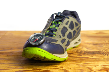 compass on sports shoes concept tourism travel. high quality photo