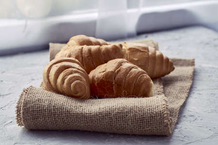 fresh croissants with chocolate filling on burlap. high quality photoの写真素材