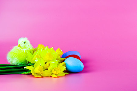 painted easter eggs a bouquet of flowers and a chicken on a pink background. high quality photoの写真素材
