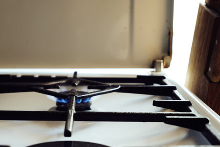 a burning gas stove on a white kitchen stove. high quality photo