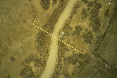 a gas pipeline pipe laid across a river in the steppe. high quality photo