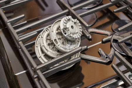 the burners removed from the gas stove lying on the table in the repair shop. high quality photoの写真素材
