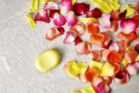 rose petals and a bar of soap on a gray textured background. high quality photoの写真素材