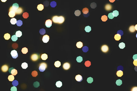 multicolored festive lights on a black background screensaver backdrop. high quality photo