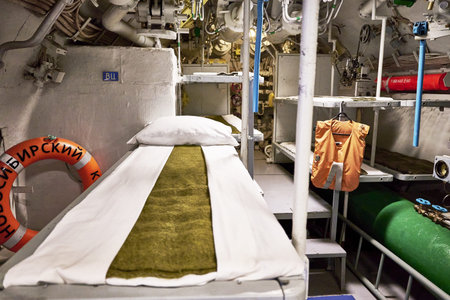 sailors' beds and other equipment in the compartment of an old diesel submarine. high quality photo