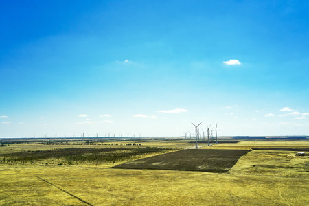 wind power plant in the steppe against the blue sky shooting from a drone. high quality photo