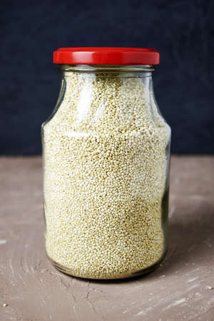 quinoa groats in a glass jar on the table. high quality photoの写真素材