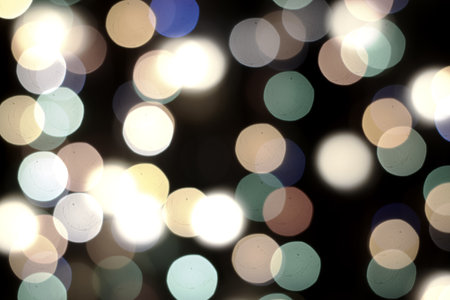 multicolored festive lights on a black background screensaver backdrop. high quality photoの写真素材