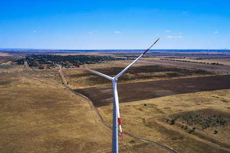 wind power plant in the steppe against the blue sky shooting from a drone. high quality photoの写真素材