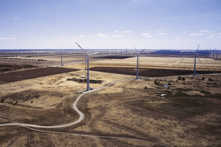 wind power plant in the steppe against the blue sky shooting from a drone. high quality photo