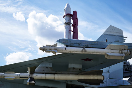 17/06/2022 Russia Moscow VDNH missile armament on the wing of the Su-27 fighter and the Vostok launch vehicle against a blue sky with clouds. high quality photoのeditorial素材