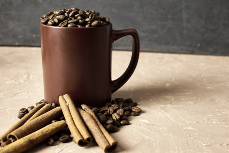 coffee beans with cinnamon and a coffee mug on the table with a copy space. high quality photoの写真素材