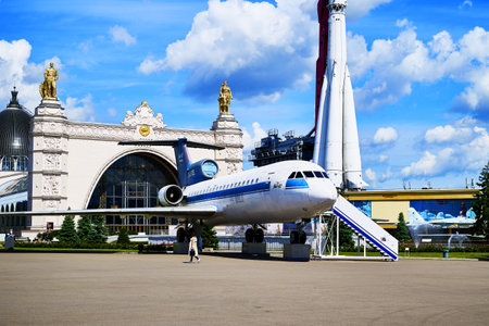 17/06/2022 Russia Moscow VDNH the Yak-42 aircraft and the Vostok launch vehicle against the background of the cosmos pavilion and the blue sky with clouds. high quality photoのeditorial素材