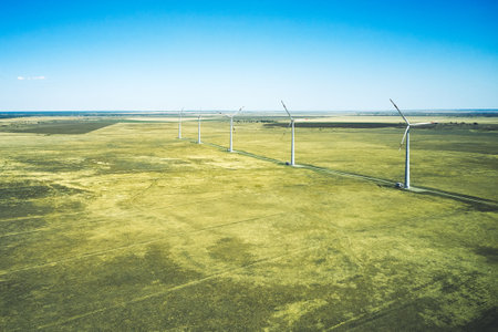 wind power plant in the steppe against the blue sky shooting from a drone. high quality photoの写真素材