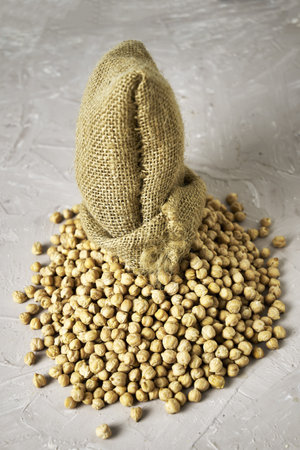 chickpeas in a canvas bag and scattered on the table. high quality photoの写真素材