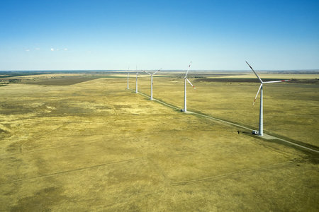 wind power plant in the steppe against the blue sky shooting from a drone. high quality photoの写真素材