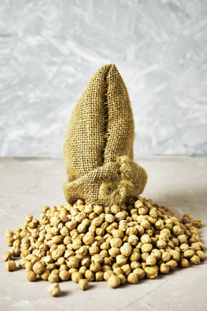 chickpeas in a canvas bag and scattered on the table. high quality photoの写真素材