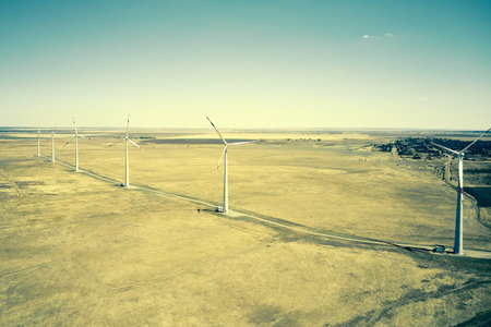 wind power plant in the steppe against the blue sky shooting from a drone. high quality photoの写真素材
