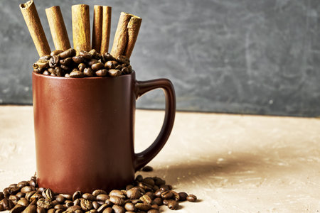 coffee beans with cinnamon and a coffee mug on the table with a copy space. high quality photoの写真素材