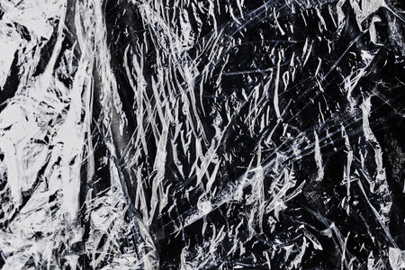 black cellophane bag close-up background texture of plastic. high quality photoの写真素材