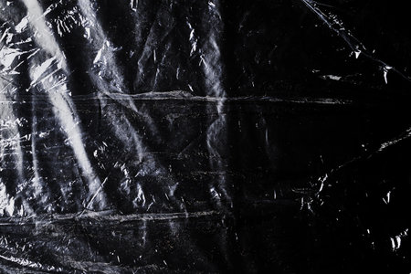black cellophane bag close-up background texture of plastic. high quality photoの写真素材