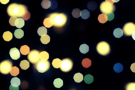 multicolored festive lights on a black background screensaver backdrop. high quality photoの写真素材