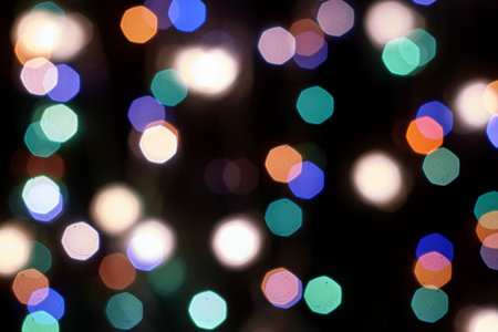 multicolored festive lights on a black background screensaver backdrop. high quality photoの写真素材