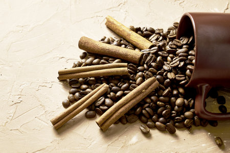 coffee beans with cinnamon and a coffee mug on the table with a copy space. high quality photoの写真素材
