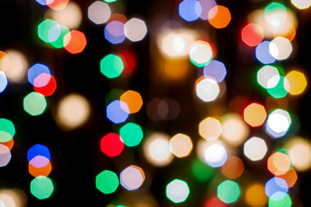 multicolored festive lights on a black background screensaver backdrop. high quality photoの写真素材