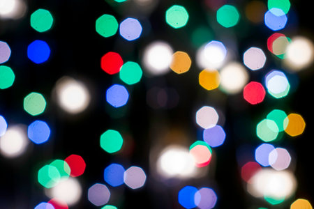 multicolored festive lights on a black background screensaver backdrop. high quality photoの写真素材