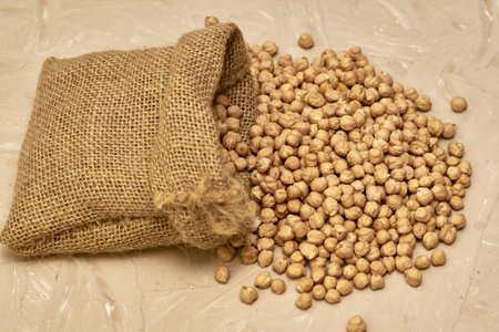 chickpeas in a canvas bag and scattered on the table. high quality photoの写真素材