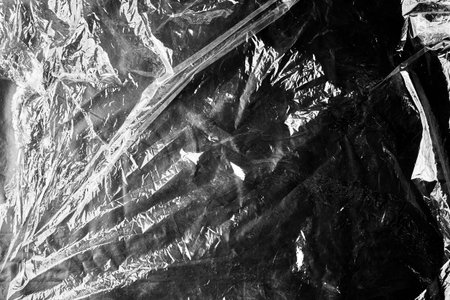 black cellophane bag close-up background texture of plastic. high quality photo