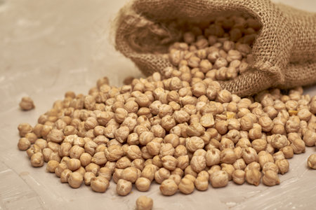 chickpeas in a canvas bag and scattered on the table. high quality photoの写真素材