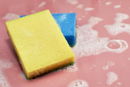soap foam and two sponges on a pink background. high quality photoの写真素材