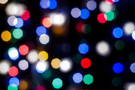 multicolored festive lights on a black background screensaver backdrop. high quality photoの写真素材