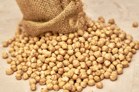 chickpeas in a canvas bag and scattered on the table. high quality photoの写真素材