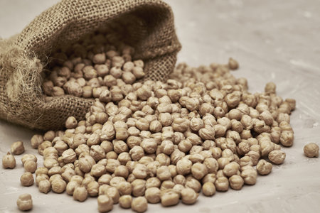 chickpeas in a canvas bag and scattered on the table. high quality photoの写真素材