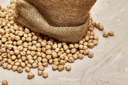 chickpeas in a canvas bag and scattered on the table. high quality photo