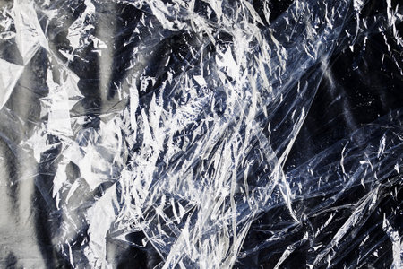 black cellophane bag close-up background texture of plasticの写真素材
