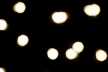 multicolored festive lights on a black background screensaver backdrop. high quality photoの写真素材