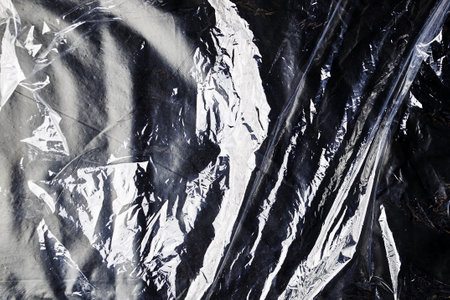 black cellophane bag close-up background texture of plastic. high quality photoの写真素材