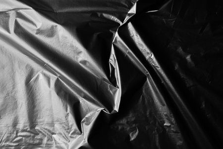 black cellophane bag close-up background texture of plastic. high quality photoの写真素材