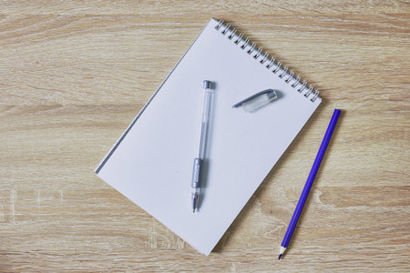 open notepad for notes pencil and pen on a wooden table with a copy space top view. high quality...