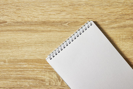 open notepad for notes on a wooden table with a copy space top view