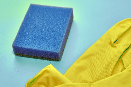 household gloves and sponge on blue backgroundの写真素材