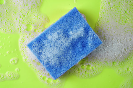 soap foam and sponge on a green backgroundの写真素材