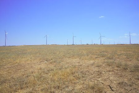 wind farm in the steppe against the blue skyの写真素材