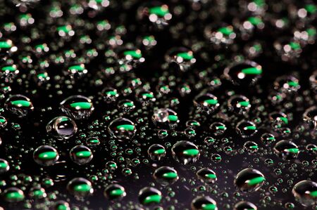 background of green-black water dropsの写真素材