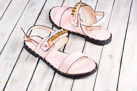 Female summer sandals on a wooden backgroundの写真素材