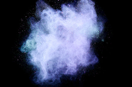 Colored powder explosion. Abstract closeup dust on backdrop. Colorful explode. Paint holi